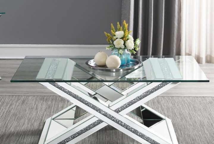 Elevate your living room with this superb modern glam coffee table. An eye-catching X-shaped pedestal base lends a chic