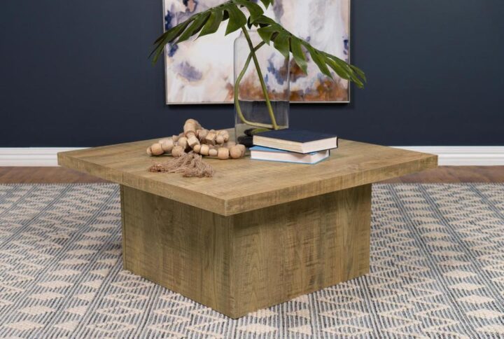 Natural ambiance brings a fresh motif to your casual spaces in the form of a square wood coffee table with the power to change up a design scheme. The square coffee table reflects a heady natural vibe with wood grain markings on natural mango finish wood products construction. Its spacious overhang top and oversized block base create delightful optical effects with a low-key feel. Centered in a casual yet elegant room