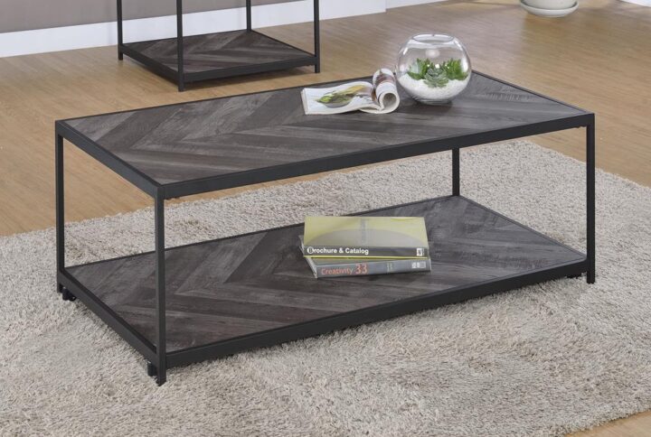Complete your industrial theme living room with this modern rustic coffee table from the Beckley collection. Modern style means a crisp structure with perpendicular straight lines for a clean silhouette. The rustic grey herringbone finish on the tabletop adds a textural element for visual interest. A convenient open shelf offers additional display or storage space beneath the tabletop