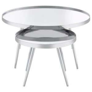 with the smaller table tucking underneath its larger counterpart to conserve space or create a waterfall effect that's sure to enchant. Round tabletops feature a raised lip and mirrored glass that adds bright reflectivity. Splayed legs ensure stability and show off a gleaming chrome finish. Together or apart