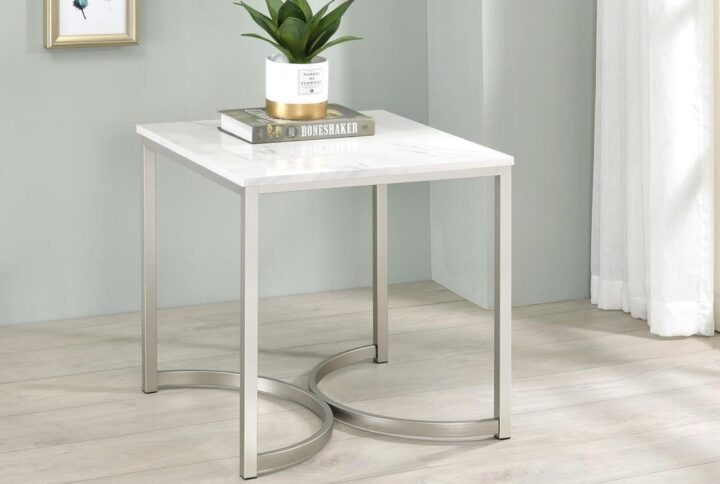 Eyes instantly gravitate to the curved base of this contemporary end table. Two U-shaped legs combine to make a stunning visual impact and support for the tabletop. The square tabletop is made from faux marble with a stunning white and grey color palette. When coupled with the silver base