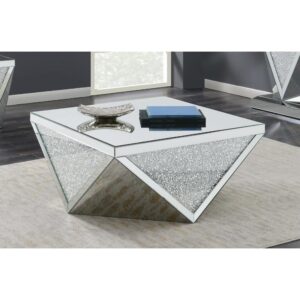 Amplify the style of a modern living room. This stunning coffee table livens up your living space with a hint of shimmering sparkle. Its base is artfully crafted into a diamond shape with alternating triangles of glittery and silvery material. A shining