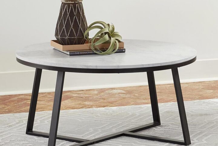 A two-tone coffee table is a terrific contemporary upgrade in your living area. The round tabletop is constructed from faux marble with hues of white and grey. Creating a stunning two-tone appearance with this matte black metal base