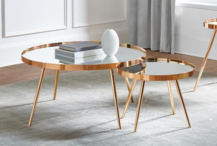 Add a retro-inspired touch with this contemporary nesting table set. Featuring a warm hue of a high-polished gold finish
