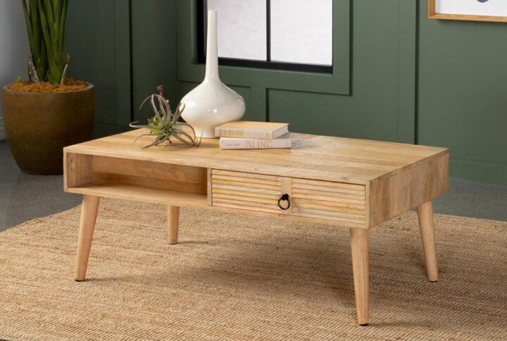 Boho-inspired elements and clean lined come together to create this refined transitional coffee table. Crafted from solid mango wood in a warm light hue and natural finish