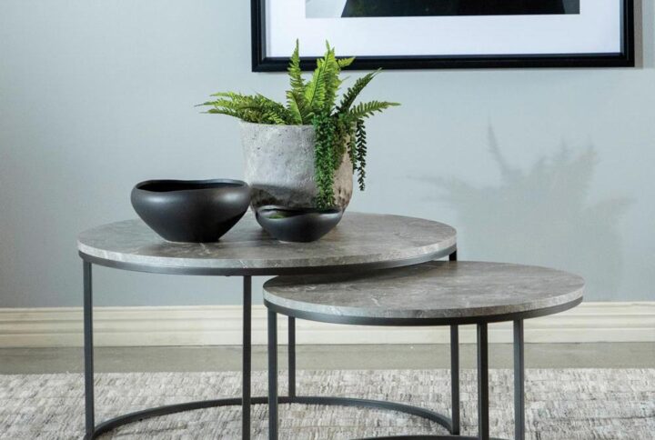 A nesting coffee table makes an interesting addition to your living space. Two round coffee tables join as one in a nesting fashion