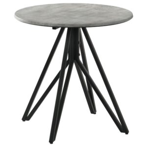 Industrial elements and sleek modern lines bring forth this modern end table. A metal butterfly-like base design of open and flared hairpin style legs in a gunmetal finish offer a striking visual interest to the furniture piece and the room in which is rests. Placed on top of the chic base is a round tabletop that portrays a molded cement for a rustic modern farmhouse flair. The cement-inspired top also offers a textured sandy feel to resemble the true material. Place this modern end table beside an accent chair or allow it to showcase a sculpture or art piece in a loft studio.