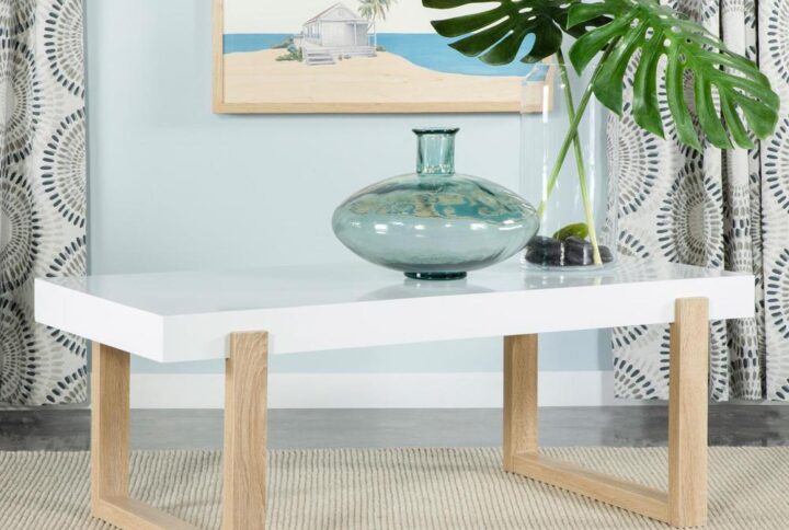 A spacious white high gloss tabletop offers a minimal look and feel to this modern coffee table. Designed with cheerful bright hues throughout