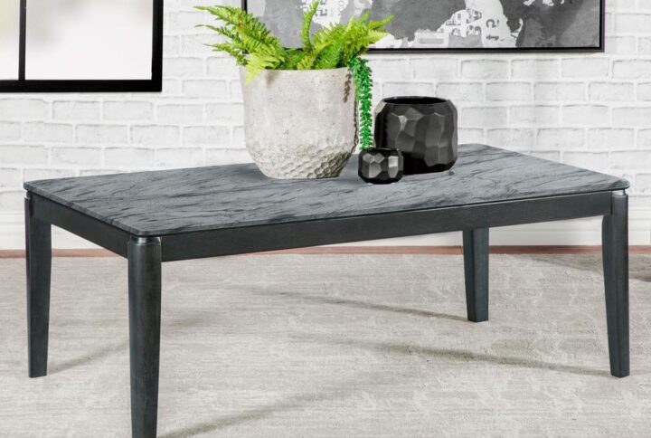 Transform a contemporary space into a minimalist home with this chic modern coffee table. This sophisticated coffee table features a spacious rectangular top that offers a faux grey marble design with realistic-looking striations and a sandy feel. The surface offers ample room for resting a drink