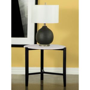 Sleek lines and a minimal aesthetic come together in this modern end table. A tripod-like base with slim black metal legs offers a stand that supports a floating round top for an edgy look. The round top also offers a textured feel and a faux white marble-inspired design