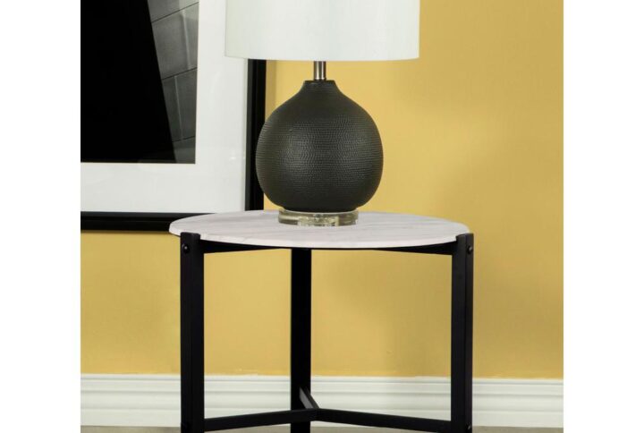 Sleek lines and a minimal aesthetic come together in this modern end table. A tripod-like base with slim black metal legs offers a stand that supports a floating round top for an edgy look. The round top also offers a textured feel and a faux white marble-inspired design