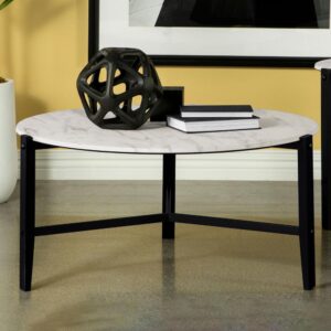Create a minimal aesthetic in your living room with this modern coffee table. Slim black metal legs come together to create a stand-like base that floats a spacious round tabletop. The round tabletop offers a faux white marble-inspired design with a textured feel