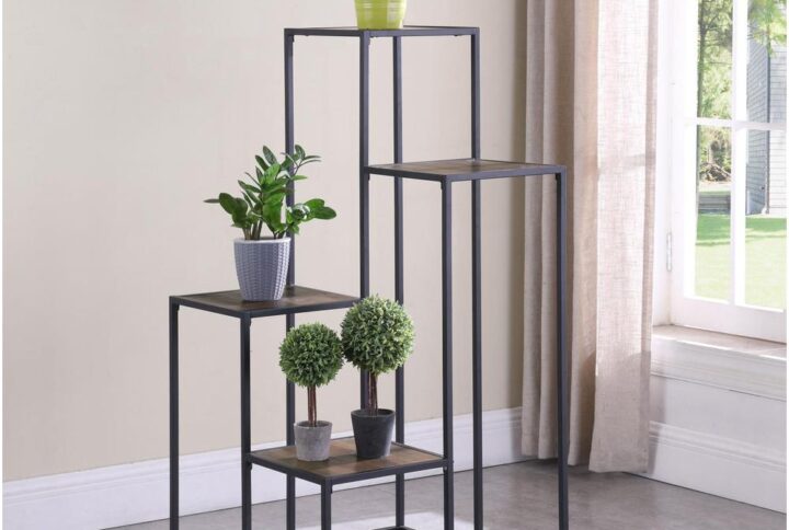 Make a statement with a tiered shelving unit. Four open shelves create the perfect place for displaying your favorite decor items. Its industrial design is enhanced with a black metal frame. Meanwhile