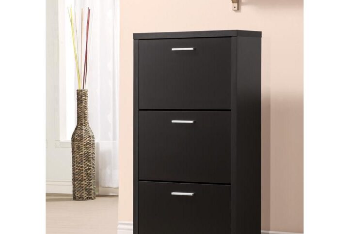 Keep shoes organized and out of sight. A minimalist design offers a tasteful look in this show rack. Each of its three drawers holds four pairs of shoes safely and securely. Enjoy a bold black finish with ornate silver hardware. Place in a dressing room