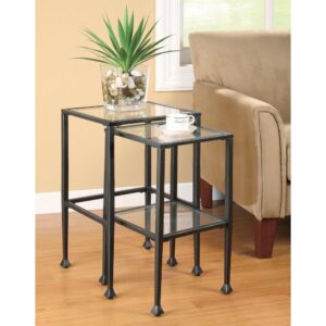 Go contemporary with a twist. This elegant nesting table set delivers a tasteful look with utility. Sleek glass table tops and a lower shelf on the smaller table pair beautifully with black metal frames. Ornate foot caps round out a stylish motif. Separate to provide handy service for guests