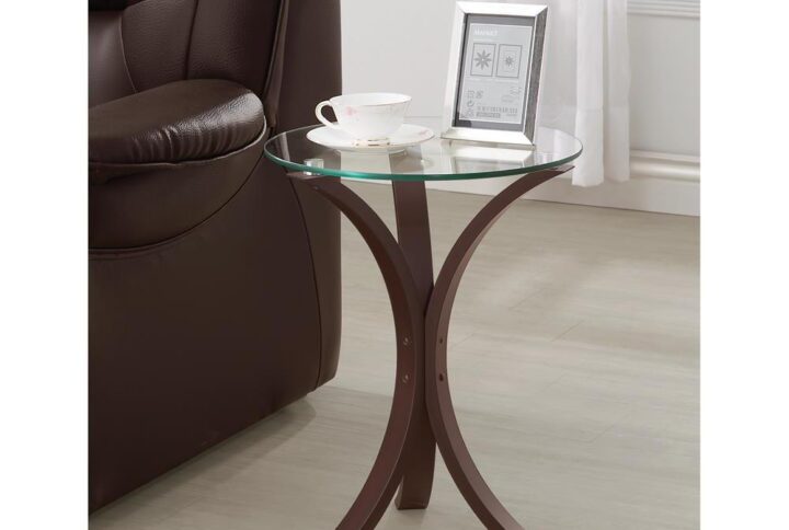 Smooth curves make this modern snack table versatile and stunning. Add instant elevation with the rounded and tempered glass table top. Delicate legs in a deep cappuccino finish transform spaces with ease. Open and airy