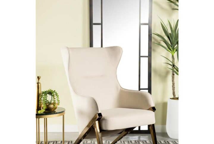 A glorious accent chair makes a magnificent display in your living space. The beautiful wingback design adds a hint of drama where you need it the most. Smooth and sleek leatherette material makes it a comfortable seating option. Sloped armrests add to its elegant design. This piece is supported on bold A-shaped leg frames.