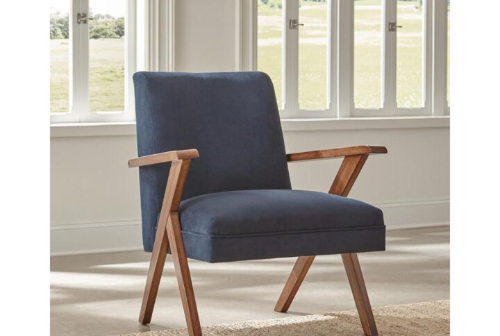 Go bold in both tones and silhouette when you add this fabric accent chair to your home. Chair is upholstered in soft dark blue fabric. Padded seat and back cushions provide hours of comfort. Rich brown armrests and legs offer warmth and support. It's a bold
