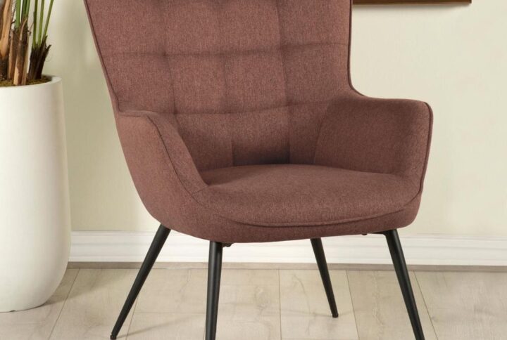 This eye-catching mid-century modern accent chair offers up a vintage vibe with its contoured design and slim legs. A biscuit tufted backrest offers modern take on the classic wingback design with flared corners. Narrow