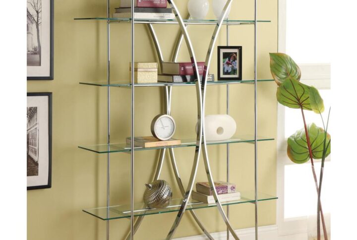 The ultimate in contemporary design rests in this eye-catching bookcase. Modern architecture meets art in a compelling silhouette blending arc-shaped and linear steel frames with clear tempered glass shelves. Four tiers offer ample space for displaying books