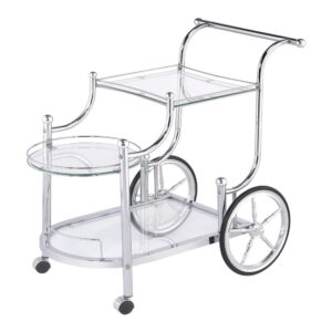 A fun traditional theme offers delightful charm that works perfectly in a traditional or transitional space. This serving cart mimics old fashioned style as it aids in delivering food and spirits to eager guests. Enjoy the captivating look of rustic wheels. Graceful curves create a compelling fluid silhouette on a cart made from metal with finishes in distressed white and chrome. Two tempered glass shelves hold beverages and implements.