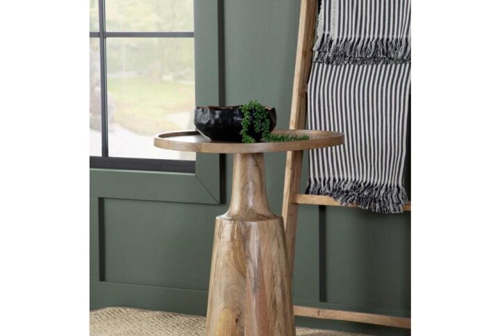 This global-inspired round accent table offers a striking design for any space. An elegant