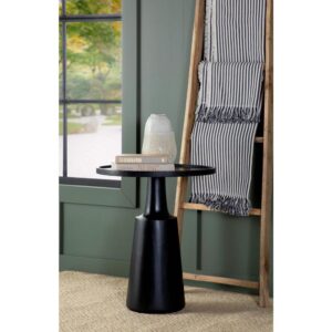 solid contoured base tapers toward the top that supports a round table surface. Raised edges define the silhouette even further and keep items in place. Made of an eco-friendly mango wood