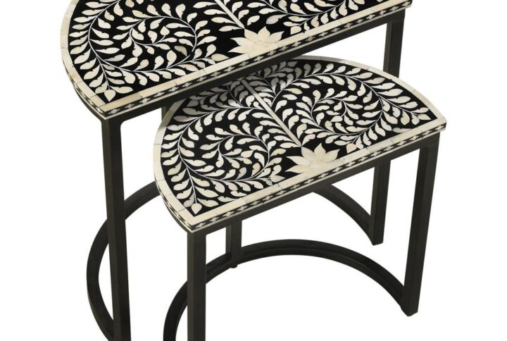 Artisan and exotic describes this elegant nesting table set with two tables that bring pure style to any living space. The Zakiya two-piece nesting table set conquers your serving needs while adding a bold and exquisite aesthetic. Set up a living room to entertain in full with these tables that feature gorgeous crafting with black finished iron forming clean lines and a semi-circle base to each table. The ornate detail of a black and bone inlay half-moon tabletop stands out to be noticed with a busy yet nature-inspired pattern. Set these tables apart as separates or close together for a larger serving space