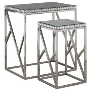 Show off your love for sparkle and shimmer this spectacular set of two silver nesting table. Your eyes will instantly be drawn to the clear crystal trim. Mirrored tabletops beautifully display your favorite decor. This nesting table set is supported on a stunning geometric shaped base made from metal. This gorgeous set will instantly add stylish flair to your space.