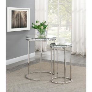 Add a sense of sparkle to your space with this set of two silver nesting tables. The stainless steel base provides a bold and durable upgrade. The round tabletops are perfect for placing beverages and small items. Sparkling gemstones surround the frame for an exciting sense of glitz and glam. A combination of steel and glass makes these nesting tables a striking addition in your home.