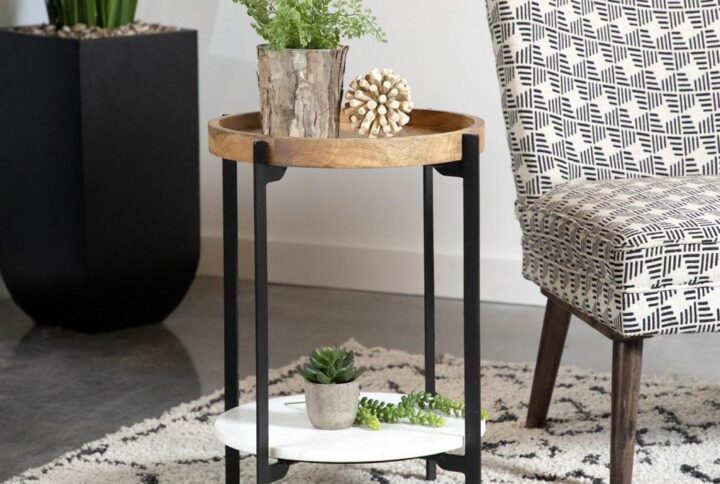 A mix of materials immediately makes this accent table one to remember. The top mango wood tabletop comes crafted with raised edges to keep items in place. Meanwhile