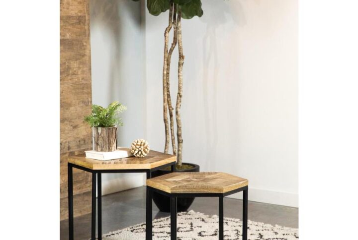 Go geometric with this set of two nesting tables. The wood hexagon tabletop makes its own display in your living area. Enhance the function of this piece by placing decor and small possessions on top. The matching black metal frame takes on the same hexagon shape with slim yet sturdy legs. The second nesting table brings extra space to display decor.