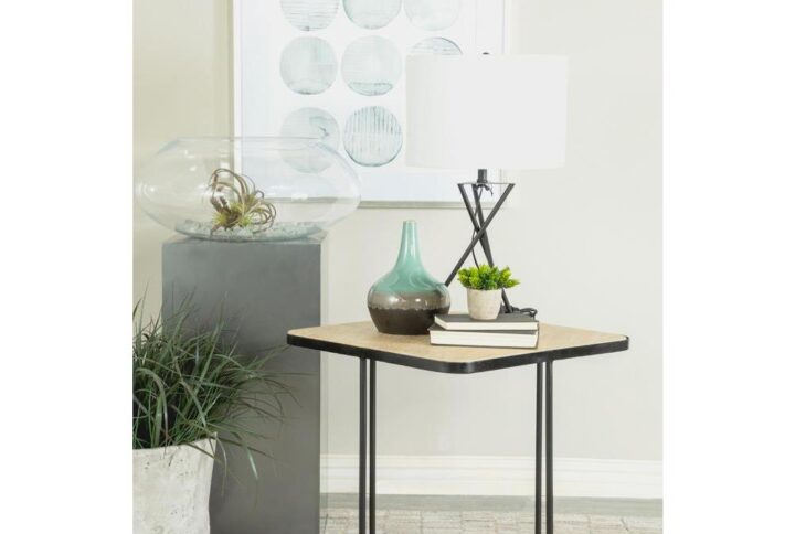 A skewed base design and contrasting colors create this contemporary accent table furniture piece. Topped with a stone-like travertine surface in a square shape