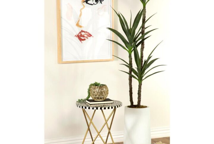 Bold prints and classic designs come together to create this contemporary accent table. Featuring a playful mosaic motif in a contrasting white bone and black resin hand-inlaid design