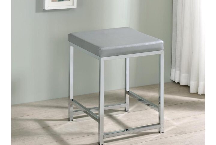 Rest comfortably in this chic contemporary vanity stool as you apply makeup or prepare for the day. Featuring a square shape design and a densely padded