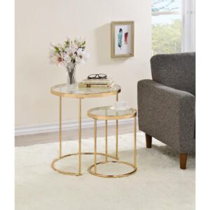 Include this sleek and sophisticated set of two nesting tables in your decor. A gold gauge steel frame makes a charming display for both pieces. The round tabletops allow you to conveniently place beverages and small items within reach. Their simplistic design ensures they beautifully blend with your decor while serving as a functional upgrade. Choose this set of two gold and glass nesting tables for your modern decor.