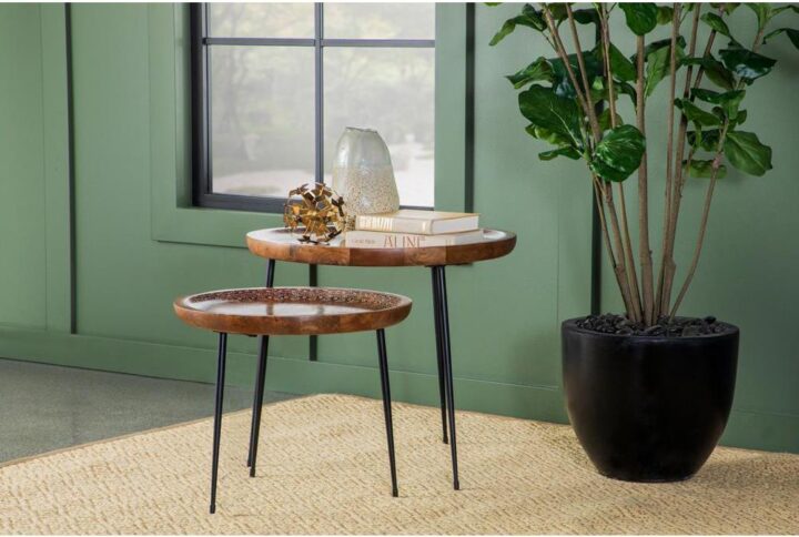 Place this boho nesting table set in a global-inspired room for a hint of warmth. Tray-like round tables with softly raised edges boasts a charming hand-painted motif in a bright white hue. Each table in this set rests on three tapered legs for a slender