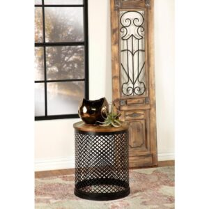 Rustic elements collide with classical designs in this industrial style accent table. Featuring a drum shape base wrapped in a perforated metal latticework grid with quatrefoil motif