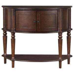 its ornate sculpting and accent detail ratchet up the decadence factor. Rich brown offers a finish that's both warm and versatile. Traditional turned legs with an attached bottom shelf expand its utility and visual elegance. Make this accent table a fixture in an entryway or a main living space.