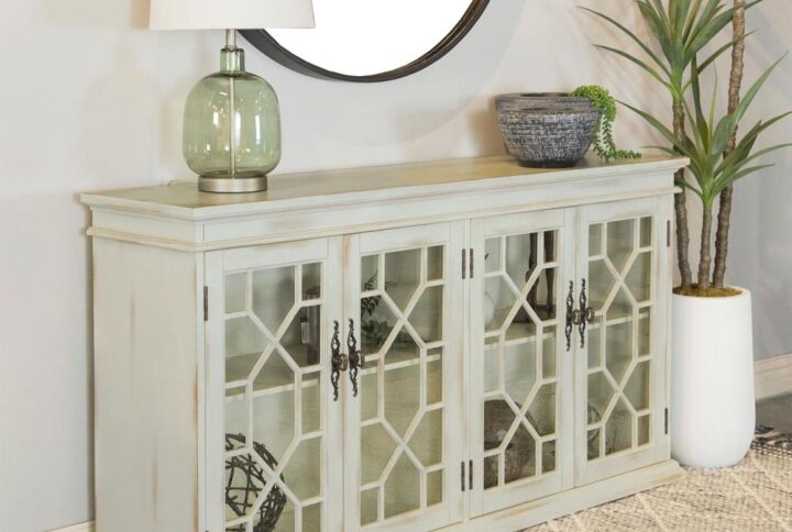 Charming traditional accents add a classic charm to this rustic accent cabinet. Covered in a weathered white finish