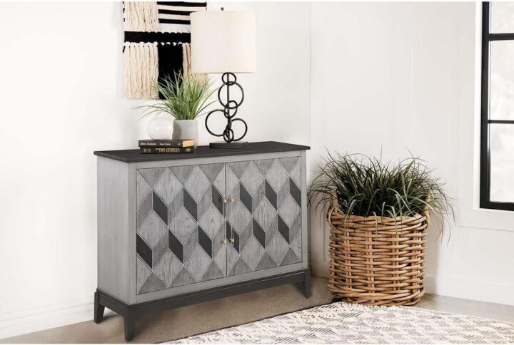 Keep your room essentials close at hand in this space-saving modern glam accent cabinet. A long rectangular frame presents a striking chevron motif in a brushed black and grey finish for a bold