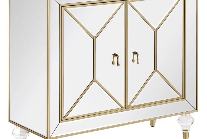 This glamorous accent cabinet lends an air of sophistication and elegance with its polished mirror surfaces and champagne accents. With an inverted beveled design along each of the dual cabinet doors