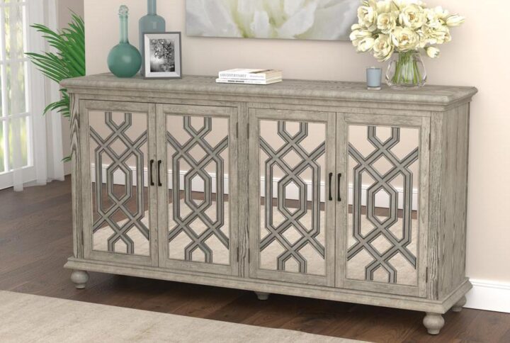 This cabinet brings you a stunning blend of elegance from a transitional glam accent cabinet. Design work on the cabinet doors calls attention to the transitional nature of the piece. The timeless antique white finish brings the glam element