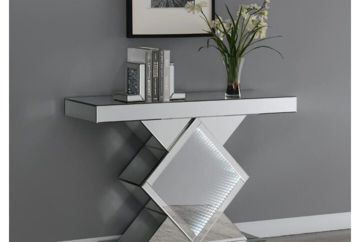 Compliments will keep coming when guests behold this extraordinary silver console table. The mirrored finish adds a twinkling touch while the center diamond-shape framed provides pizzazz. A spacious rectangular tabletop allows for display of decor