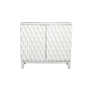 Creative carved door panels make this exceptional accent table an unforgettable piece in your entryway. The antique white finish adds an elegant touch. Geometric style patterns on the two cabinet doors provide texture and visual interest. A single shelving unit inside the cabinet provides storage space. This piece is supported on tapered legs.