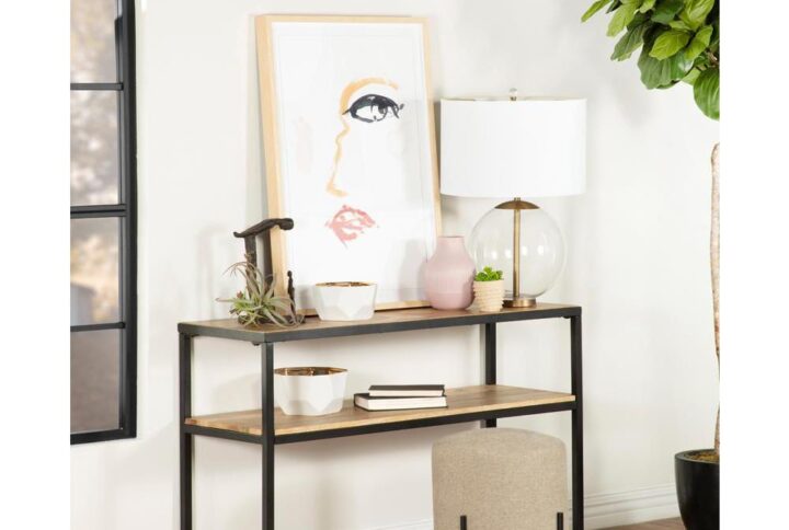 Clean lines and open shelving enhance this industrial style console table. Designed with an exposed metal frame in a black finish that supports two eco-friendly mango wood shelves