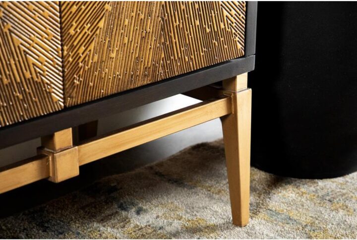 A breathtaking accent table will add life into your entryway or living space. The unique sunburst design on the two cabinet doors makes for a stunning effect. Its two tone design adds to its stylish appeal. This piece is supported on angled and tapered legs. Cabinet doors remain shut with a magnetic closure.