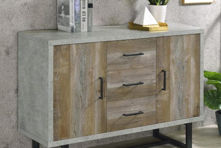 Rustic elements and industrial touches complete with overall minimal style of this contemporary accent cabinet. An outer edge of a faux cement finish reflects the gray undertones of the weathered oak drawer and cabinet panels. With a bold contrast and expressive accent