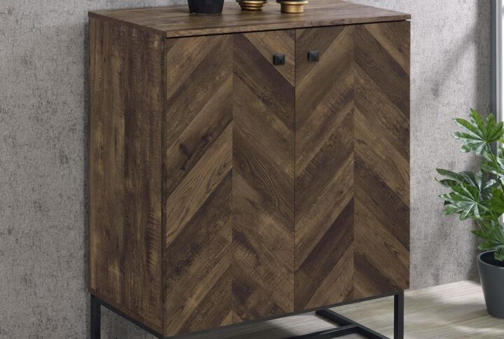 A classic herringbone pattern lends a traditional flair to this contemporary accent cabinet. With a rustic oak finish