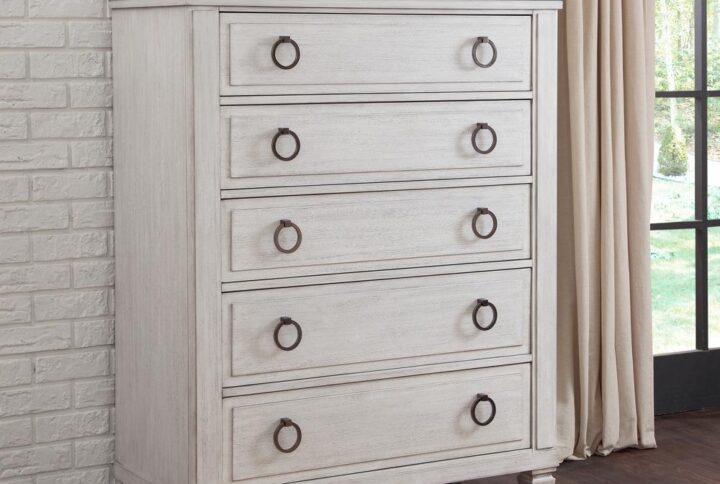 The Salter Path 5-Drawer Chest is a casual classic with modern touches and designer details.  The White Oyster wire-brushed finish with flecks of gray offers a natural textured look.  Antiqued silver ring pulls and square tapered feet add flair to this beautiful chest.  Also features roller-bearing side glides for easy drawer operation and English dovetail for durability.